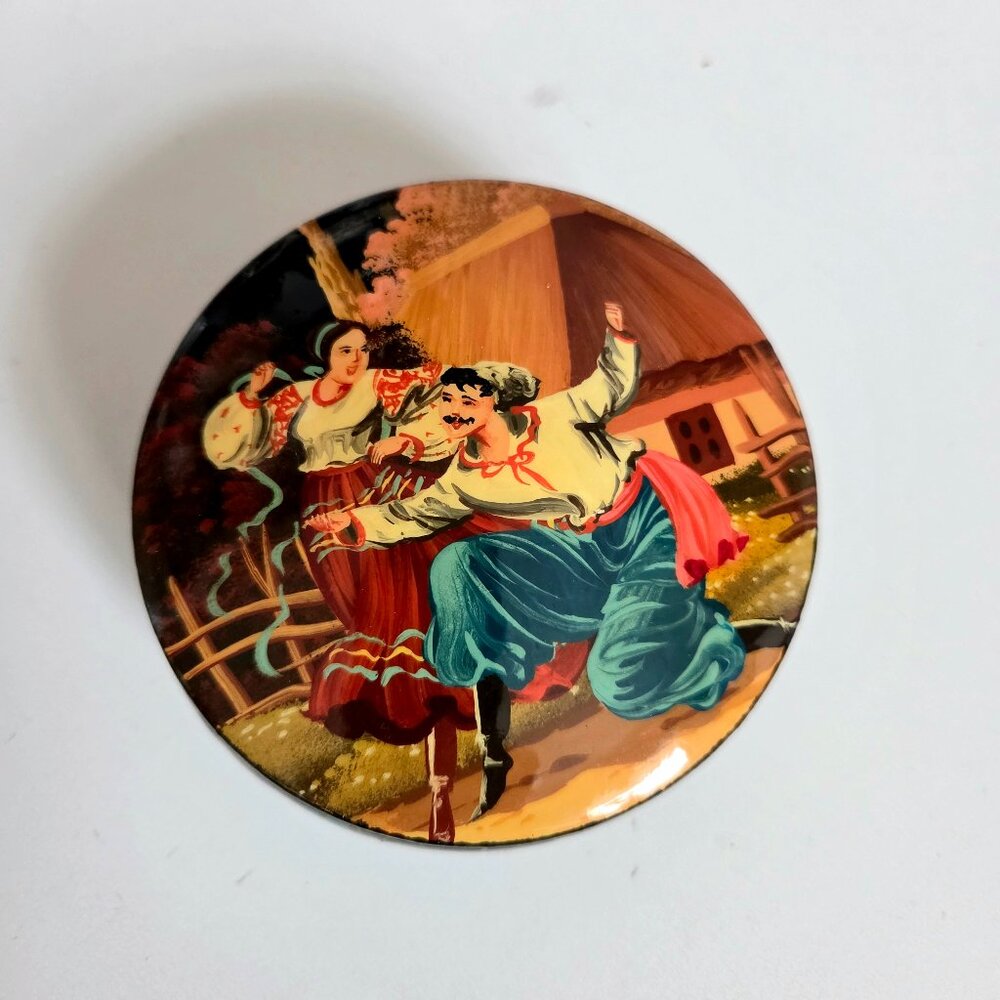 Ukrainian handmade lacquered round jewelry box with folk scene dancing couple.